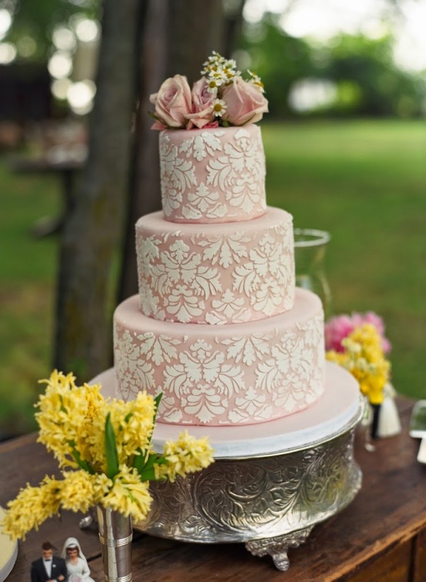 Pastel pink wedding cake on silver stand